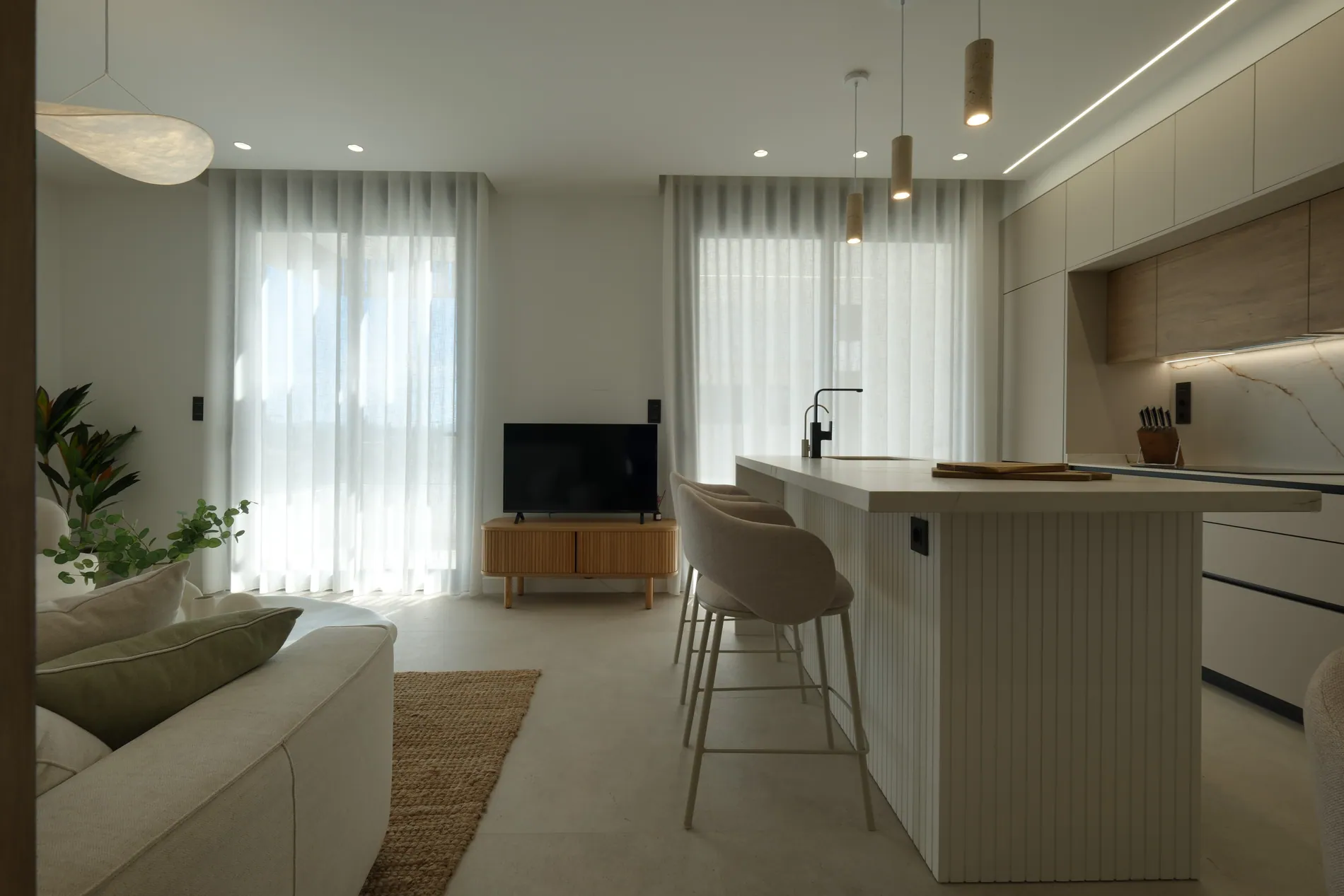 Bright open-plan living room and kitchen with sheer curtains, edited with Stager AI HDR