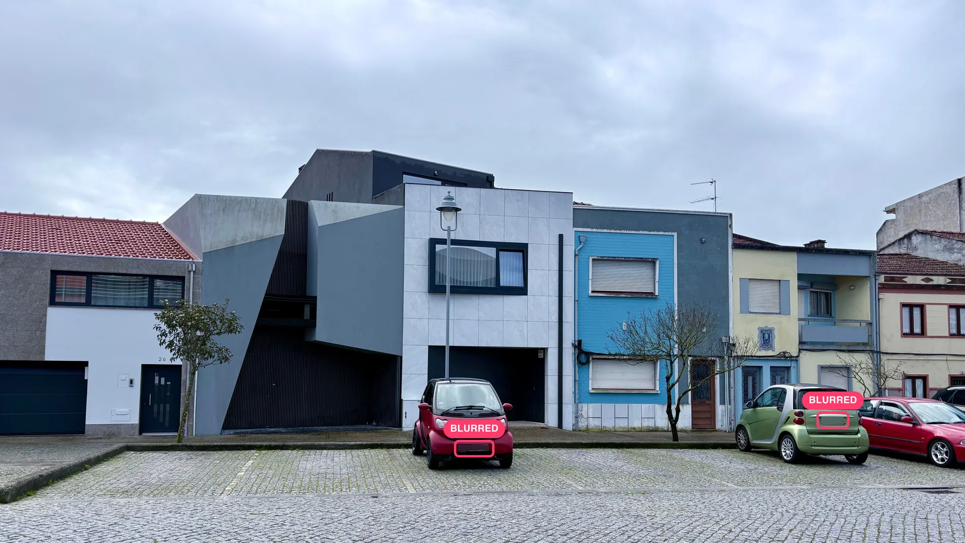Street of townhouses with parked cars, license plates marked where Stager AI found them