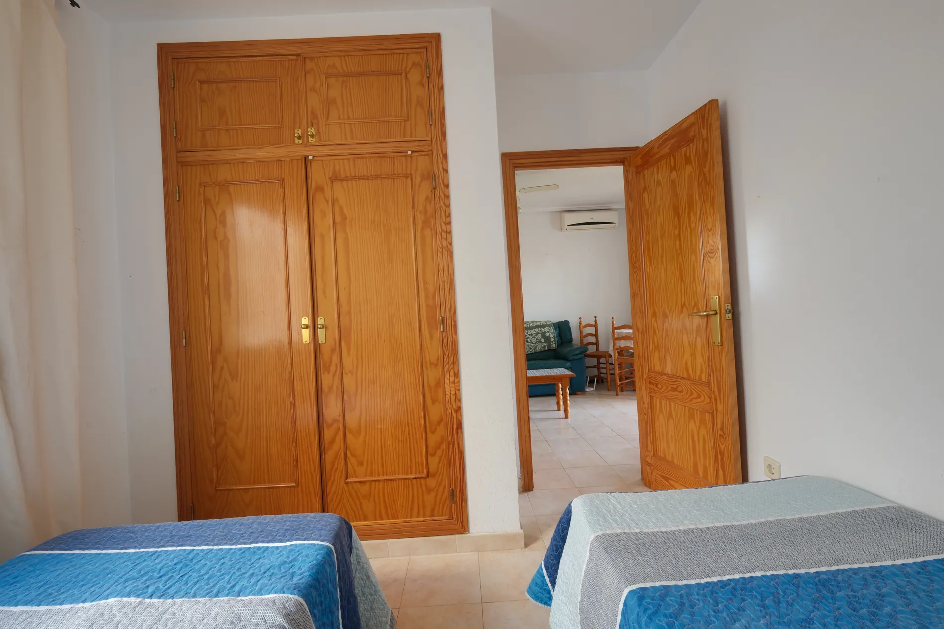 Bedroom photo taken with a tilted camera before and leveled after AI image straightening by Stager AI