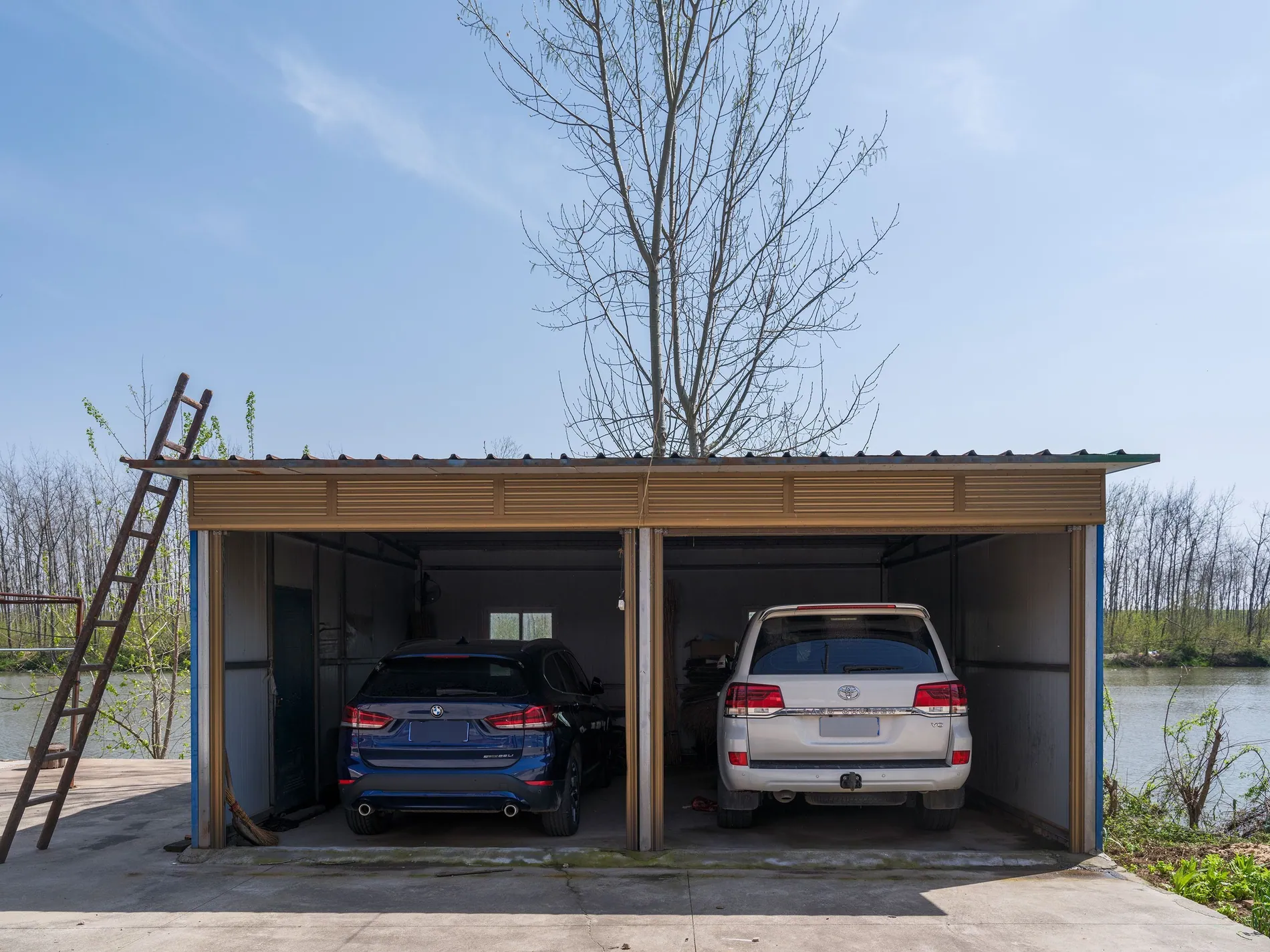 Open garage with two parked cars, rear license plates blurred by Stager AI