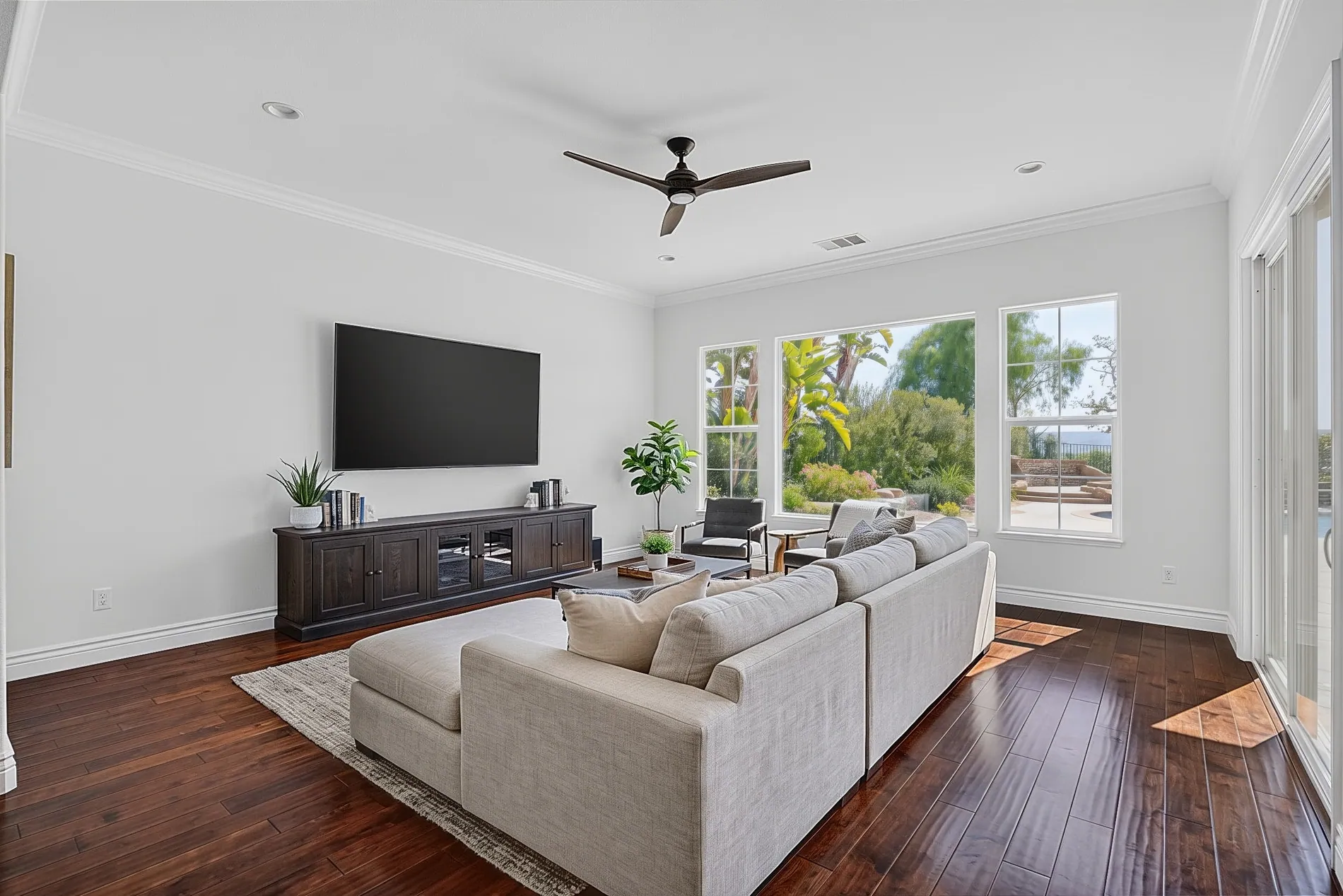 Same living room with a clean black TV screen after Stager AI editing