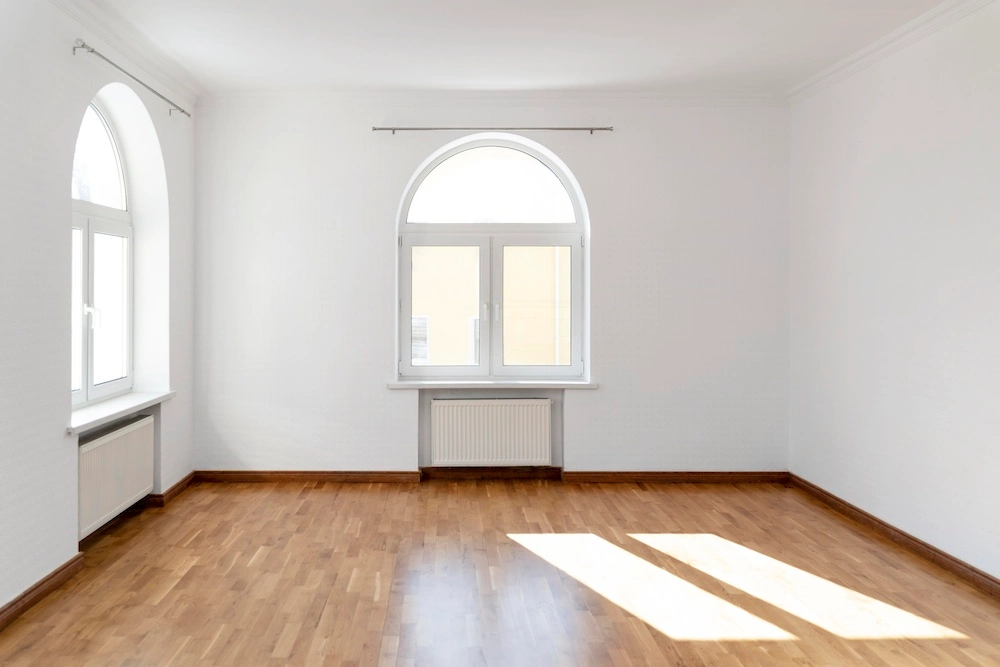 Empty room virtually staged as a Scandinavian home office with a light desk and plants by Stager AI